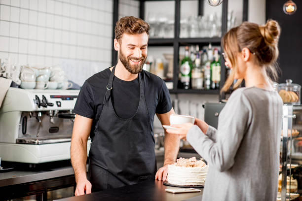 istock Barista with client at the cafe 894623982