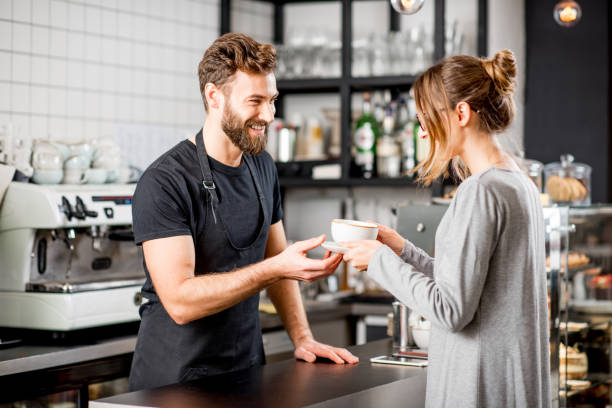 istock Barista with client at the cafe 894624010