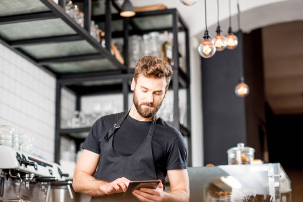 istock Waiter with tablet at the cafe 894624166