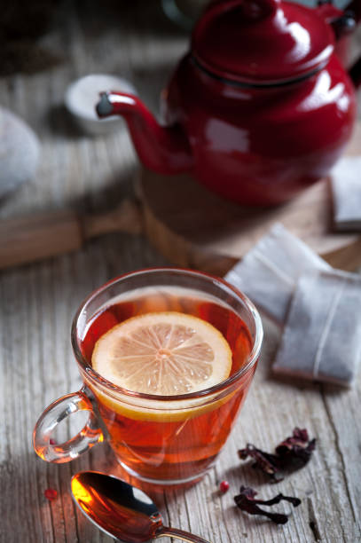 istock Glass with red tea on rustic wooden table 894626978
