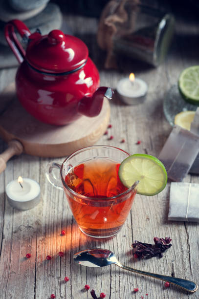 istock Glass with red tea on rustic wooden table 894629202