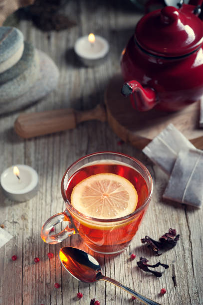 istock Glass with red tea on rustic wooden table 894629248