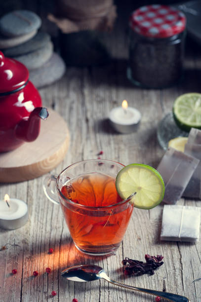 istock Glass with red tea on rustic wooden table 894629272
