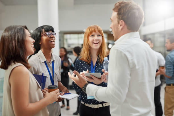 He makes success sound easy Cropped shot of a group of businesspeople having a conversation in an office Connection stock pictures, royalty-free photos & images