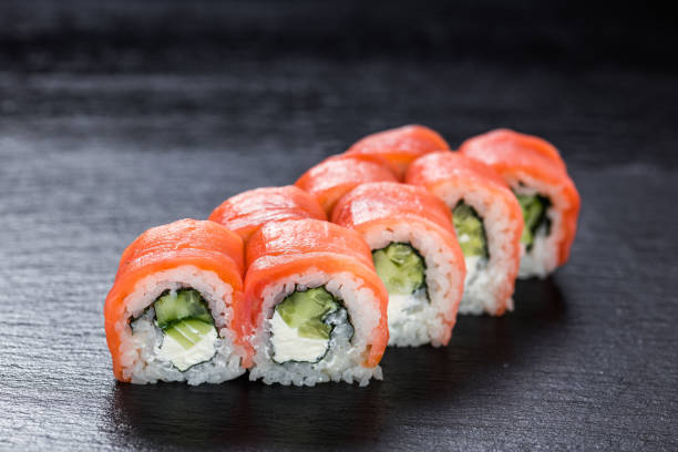 istock Philadelphia makizushi roll with smoked salmon arranged on stone background 894647442