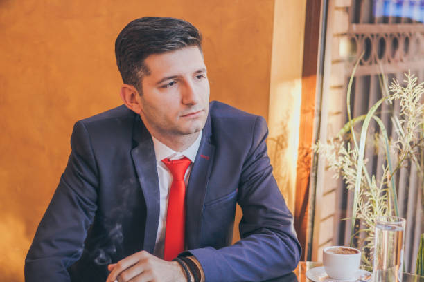 istock Young elegance man in cafe smoke cigarette. 894650084