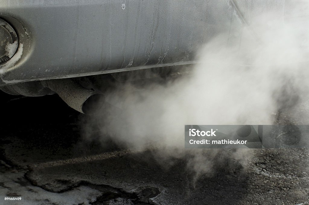 Close-up of a car's tailpipe with smoke coming out  Car smoke Exhaust Pipe Stock Photo