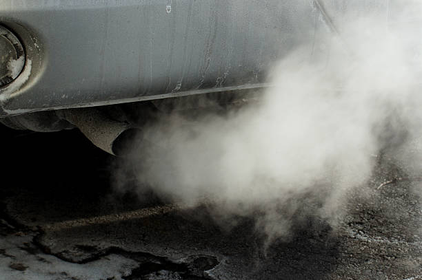 Close-up of a car's tailpipe with smoke coming out  Car smoke exhaust pipe photos stock pictures, royalty-free photos & images