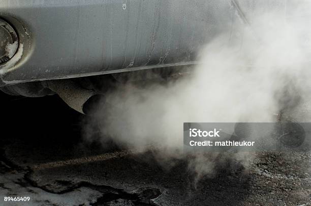 Closeup Of A Cars Tailpipe With Smoke Coming Out Stock Photo - Download Image Now
