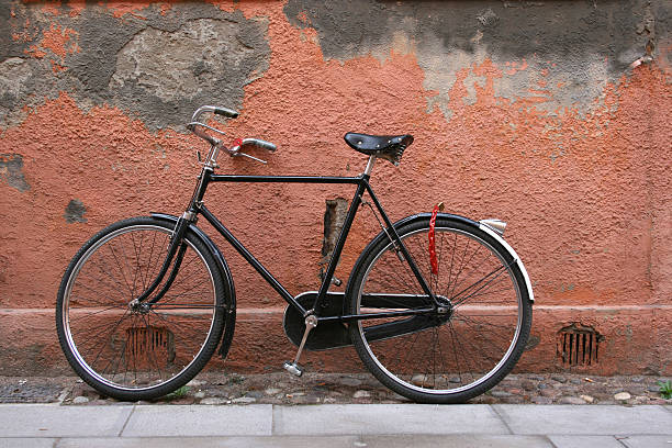 Black bike leaning on a grunge wall