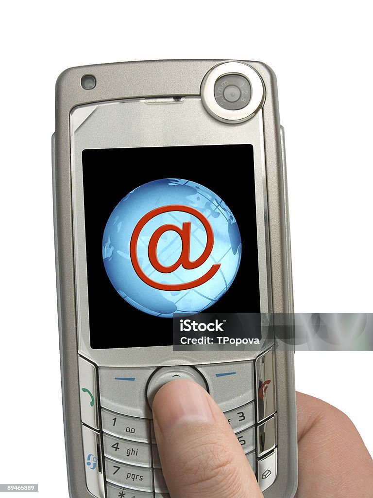 Mobile phone in hand, symbol @ and Earth on display  Color Image Stock Photo