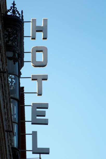 istock Silhouetted hotel sign, clear blue sky background. 894659400