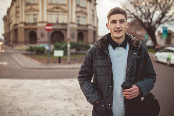 istock Cute guy with coffee on the street 894667914