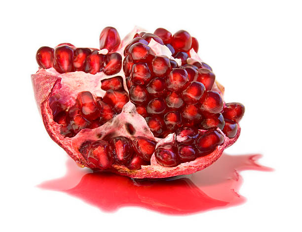 half of juicy ripe pomegranate (isolated, clipping path) stock photo
