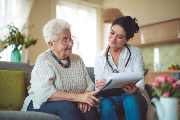 istock Social worker is visiting a senior woman 894681370