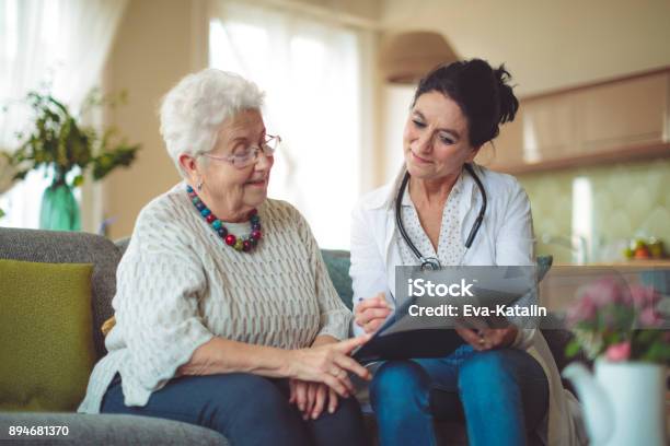 Social Worker Is Visiting A Senior Woman Stock Photo - Download Image Now - Senior Adult, Doctor, Nurse