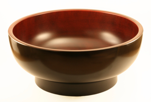 Black ceramic bowl closeup isolated on white background