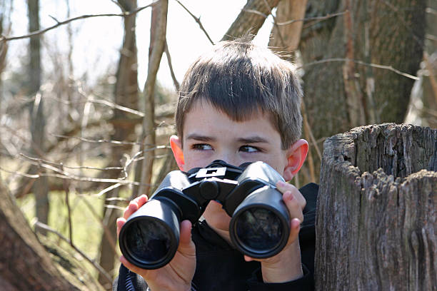 ragazzo con binocolo - binoculars watching optical instrument closed foto e immagini stock