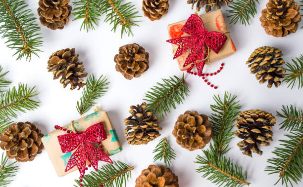 istock Christmas presents with pine cones festive background 894690706