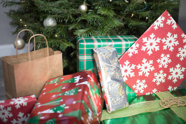 istock Gifts Presents In Front Of Tree 894690728