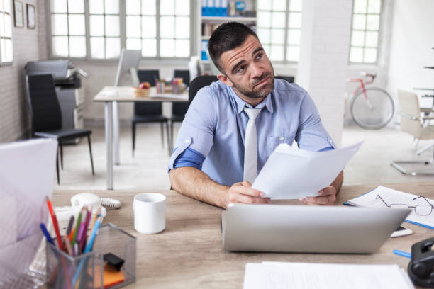 istock Worried young businessman at workplace 894696620