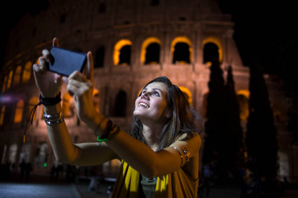 istock Smiling tourist taking night selfie in Italy 894696642