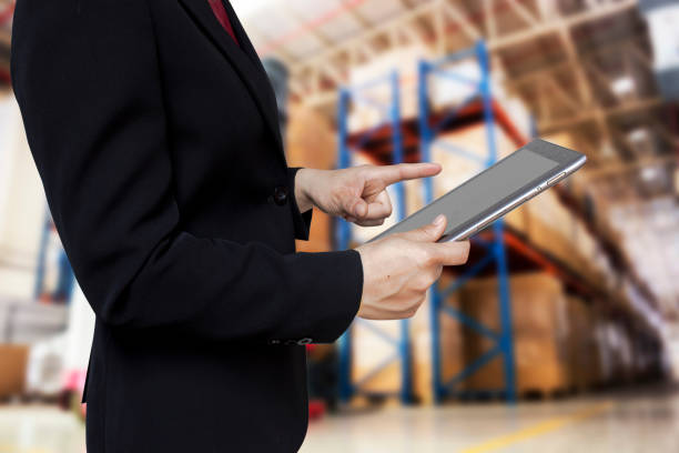 istock Midsection Of Businesswoman Using Digital Tablet While Standing In Warehouse 894700024