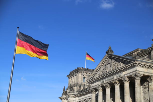 istock Low Angle View Of Flag On Building Against Blue Sky 894703642