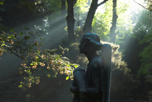 statue of on angel in mystical autumn light, on a 19th century cemetary in Unna, Germany