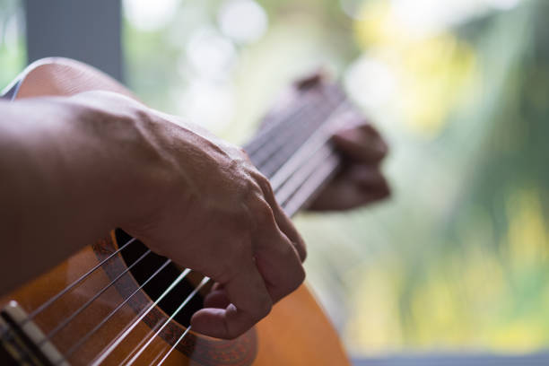 istock Close-Up Of Man Playing Guitar 894706834