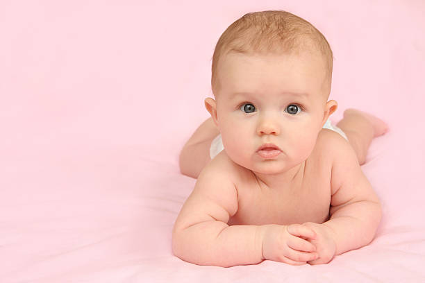 Newborn girl on pink Background stock photo