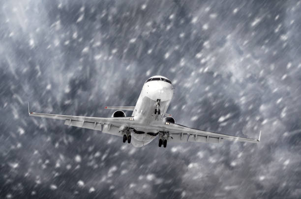 istock Airplane approaching on a landing in snowstorm bad weather. 894720766