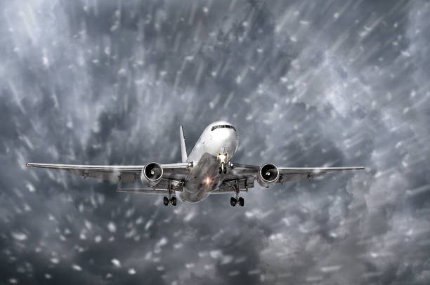 istock Airplane approaching on a landing in snowstorm bad weather. 894720794