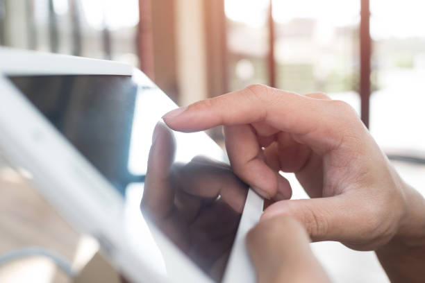 istock Close-Up Of Businessman Using Digital Tablet At Office 894723530