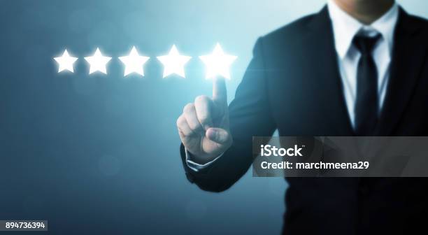 Businessman Pointing Five Star Symbol To Increase Rating Of Company Stock Photo - Download Image Now