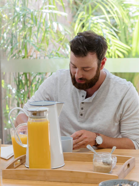 istock portrait of a handsome man having breakfast 894741078