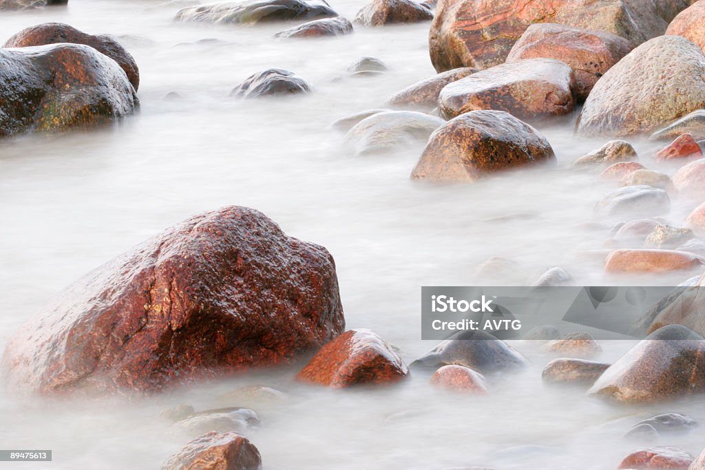 Soft Water Long time exposure makes the water look like fog or clouds Boulder - Rock Stock Photo