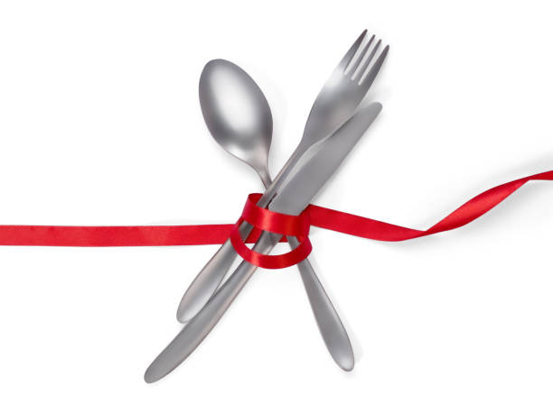 istock Fork, spoon and knife tied with a red ribbon isolated on white with clipping path 894760122