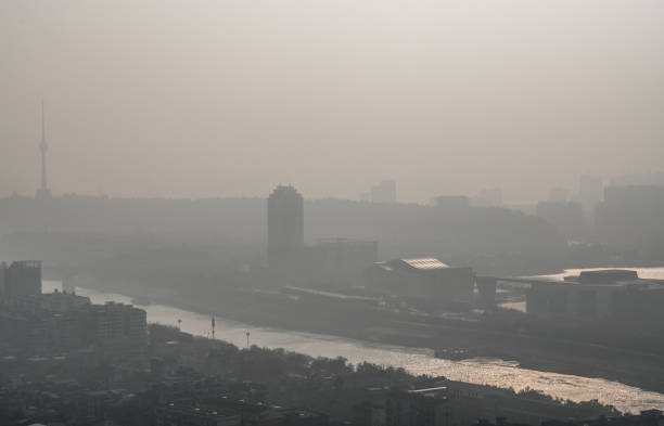 Sunrise on pollution peak day in Wuhan central China with visible dirty haze in the air Sunrise on pollution peak day in Wuhan central China with visible dirty haze in the air with view of tortoise mountain and han river low photos stock pictures, royalty-free photos & images