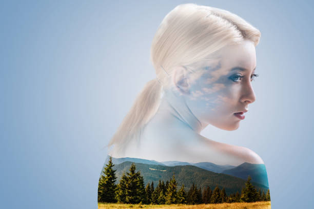 istock Pensive young woman dreaming against landscape background 894776742