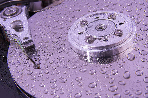 disco rígido macro-gotas de água na superfície - machine part built structure hard drive circuit board - fotografias e filmes do acervo