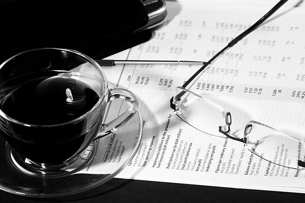 Business morning with coffee, glasses and report stock photo