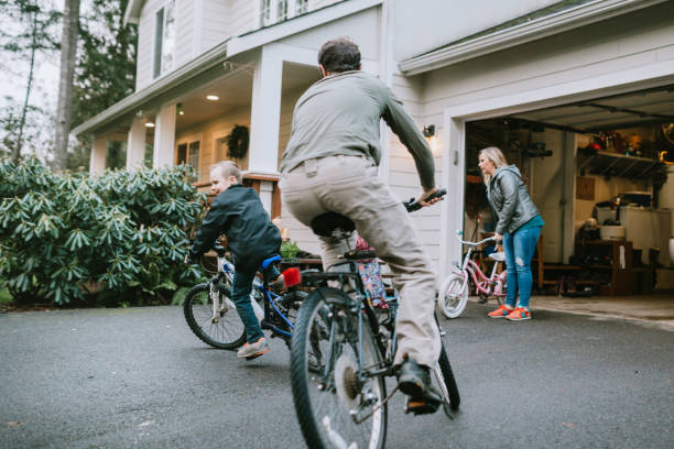 Family Riding Bikes in Home Driveway stock photo