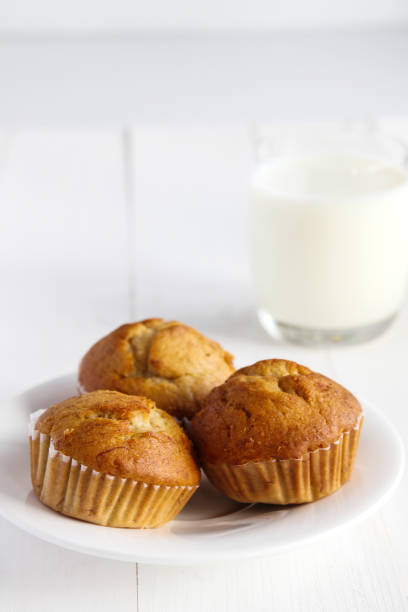 istock Banana cakes with milk on wooden table. 894826410