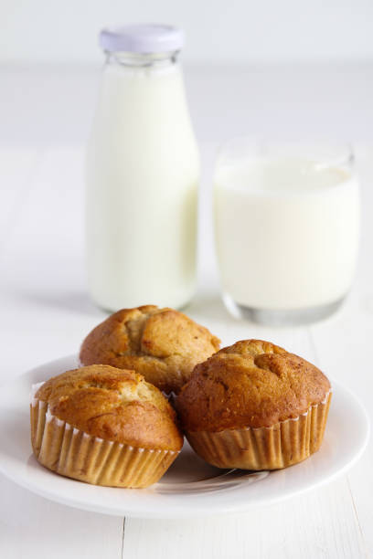 istock Banana cakes with milk on wooden table. 894826416