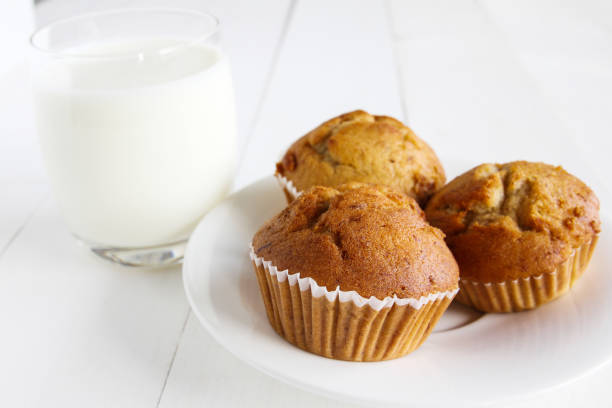 istock Banana cakes with milk on wooden table. 894826434