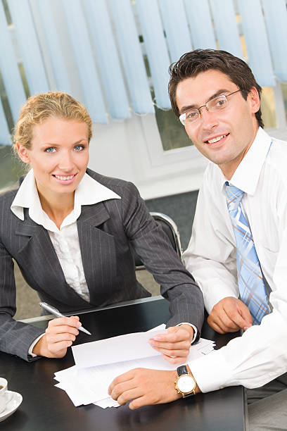 istock Two businesspeople working together at office 89482649