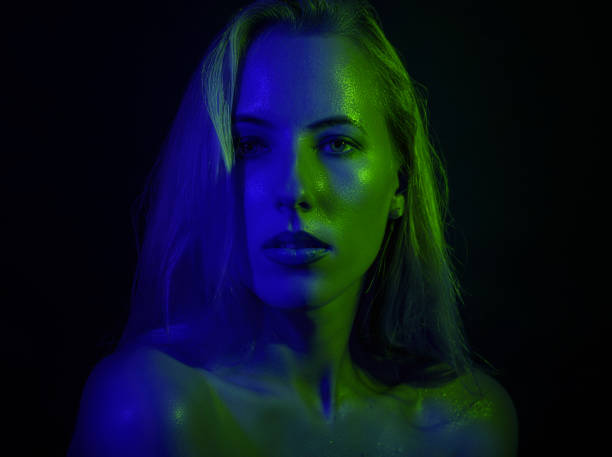 istock Portrait of a woman with colored light. 894841078