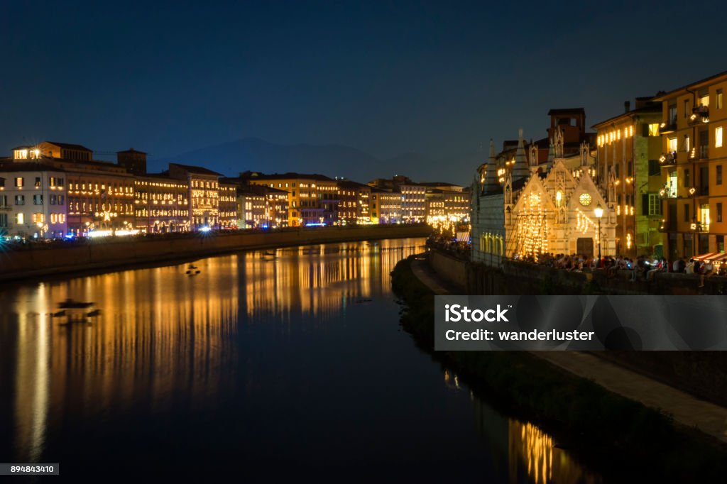 Buildings lining the Arno River are illuminated at night during the Luminaria Festival, an annual event on June 16th honoring a patron saint, San Ranieri, Pisa, Italy, Europe. Luminaria Stock Photo