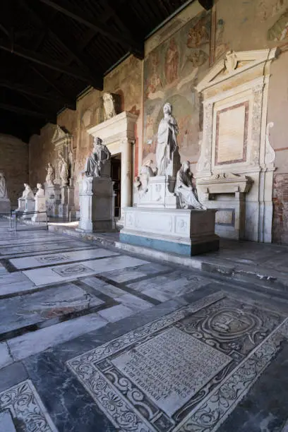 Photo of Camposanto Monumental Cemetery, created in the 12th century to be a burial for Pisa's upper class, showcases beautiful art within its cloisters including floor tombs, ancient Roman sarcophagi and sculptures dating from 3rd century, and fresco paintings da